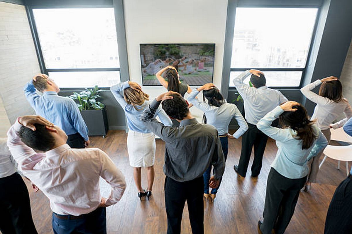 Group of office workers doing a guided movement session